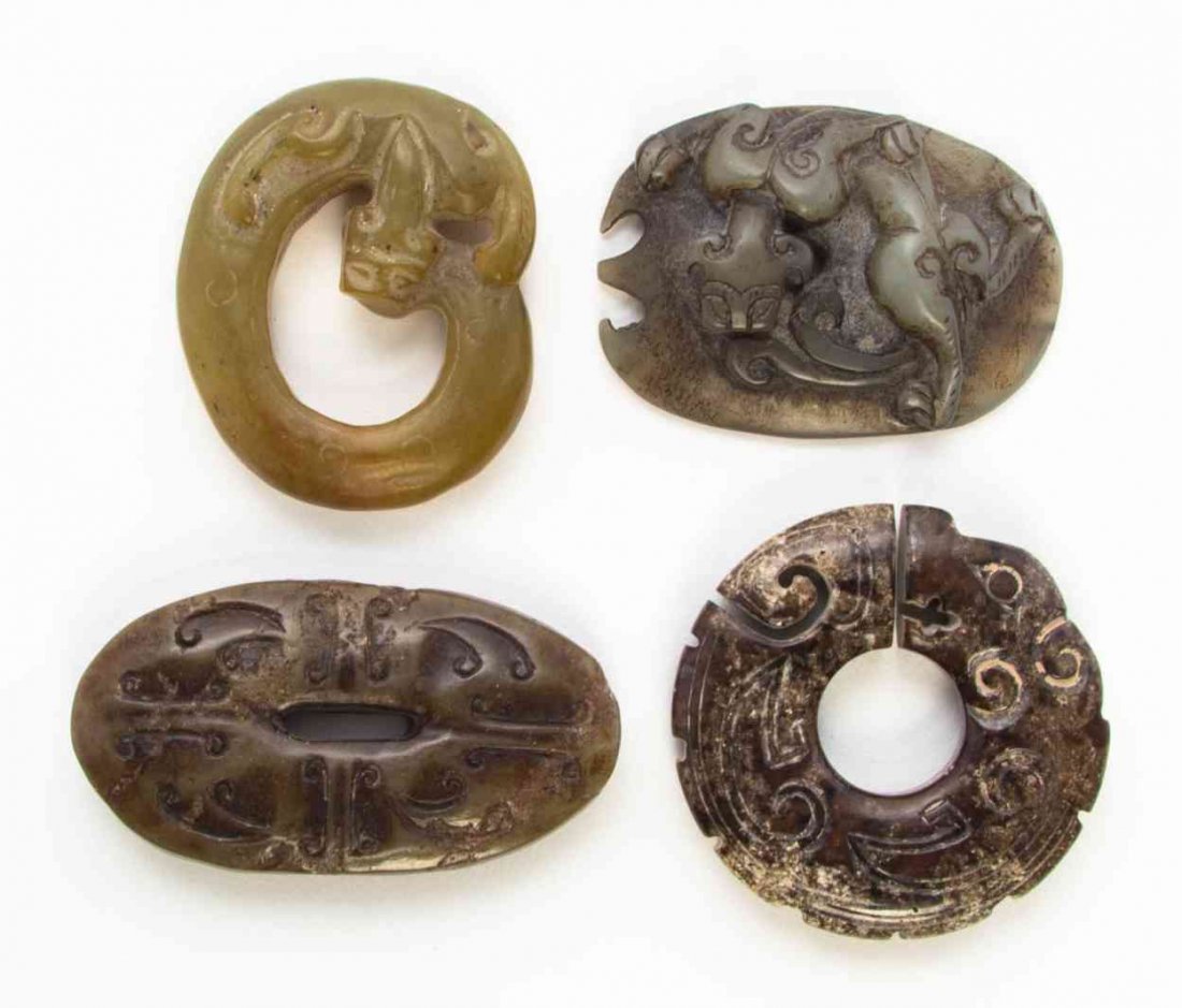 Three Carved Jade Articles, Height of first 2 3/16: Three Carved Jade Articles, comprising a coiled chilong, a plaque with a relief carved chilong and an oval, pierced plaque with incised C-scrolls, together with a hardstone coiled beast plaque. Height