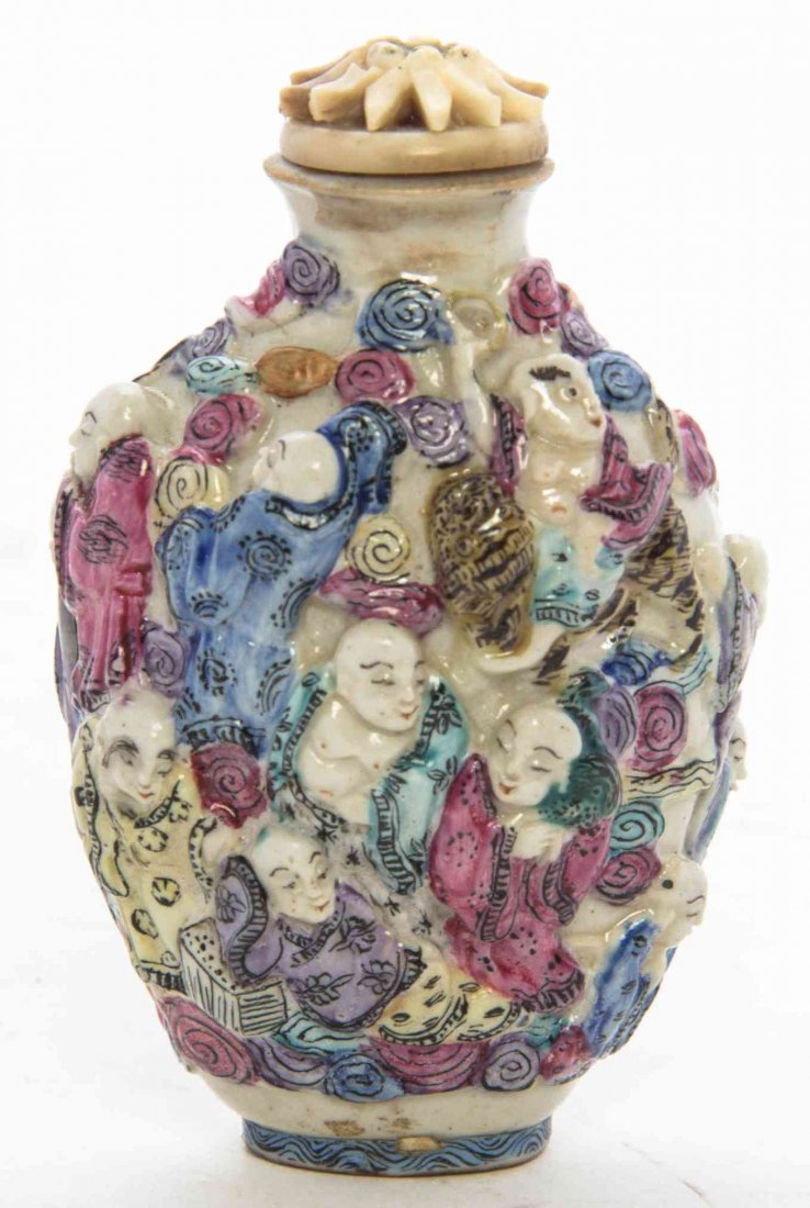 A Mounded Porcelain Snuff Bottle, Height 2 7/8 inches.: A Mounded Porcelain Snuff Bottle, depicting the 18 arhats. Height 2 7/8 inches.