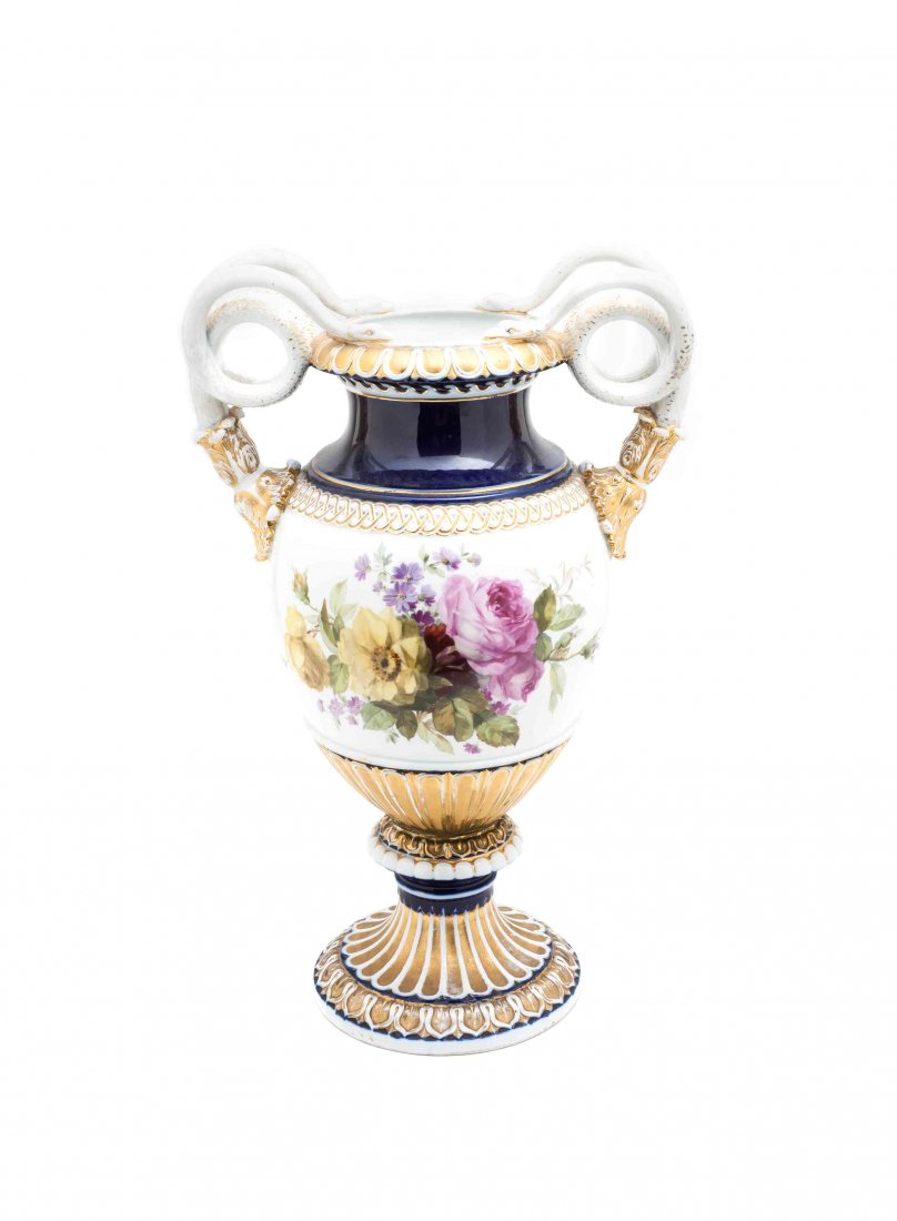 A Meissen Porcelain Urn, Height 19 inches.: A Meissen Porcelain Urn, 19th century, of baluster form mounted at the shoulders with twin scrolling snake form handles, the body painted to show a floral spray on a cobalt ground, raised on a circula
