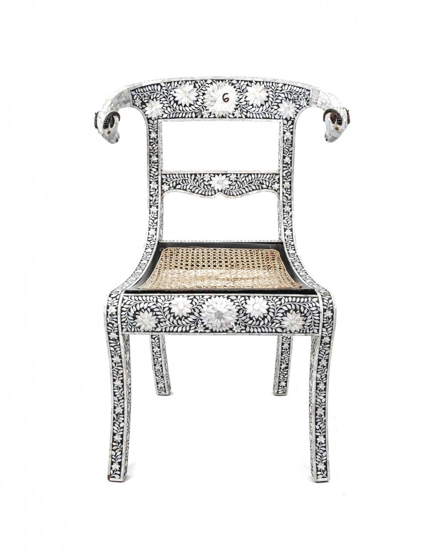 An Indian Export Mother-of-Pearl Inlaid Side Chair,: An Indian Export Mother-of-Pearl Inlaid Side Chair, the crest ending in ram's heads with carved horn detailing, with caned seat and sabre legs, inlaid overall with floral decoration. Height 34 1/2 inc