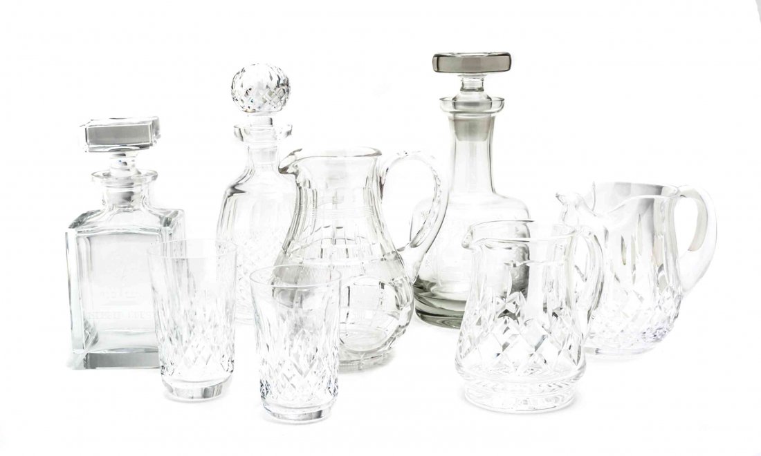 A Collection of Sixteen American Glass Table and Bar: A Collection of Sixteen American Glass Table and Bar Articles, including three cut and molded glass decanters, one example from Waterford, three water pitchers and ten Waterford glasses. Height of tal