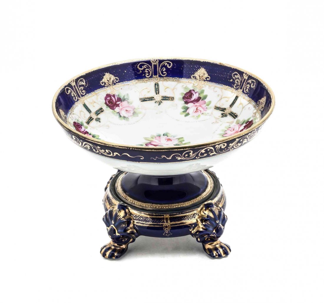 A Nippon Compote, Height 7 1/4 inches.: A Nippon Compote, having a floral spray decorating the center of the bowl, a cobalt trim above a floral spray and scrolling gilt painted border, the exterior having a cobalt and scrolling gilt painted