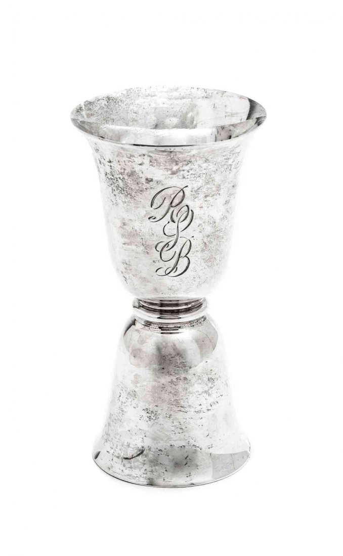 A Sterling Double-Ended Jigger, Height of first 3 3/4: A Sterling Double-Ended Jigger, BIRKS, with bell-shaped bowls, together with a pair of faux horn salad servers mounted with a band of chased silver; 1 ozt 10 dwt weighable. Height of first 3 3/4 inche