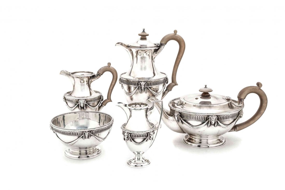 An English Silver Five-Piece Tea and Coffee Set Height: An English Silver Five-Piece Tea and Coffee Set William Comyns & Son, London, 1913 comprising a teapot, coffee pot, creamer, small pitcher, and waste bowl, each decorated with swags and ram heads; 81