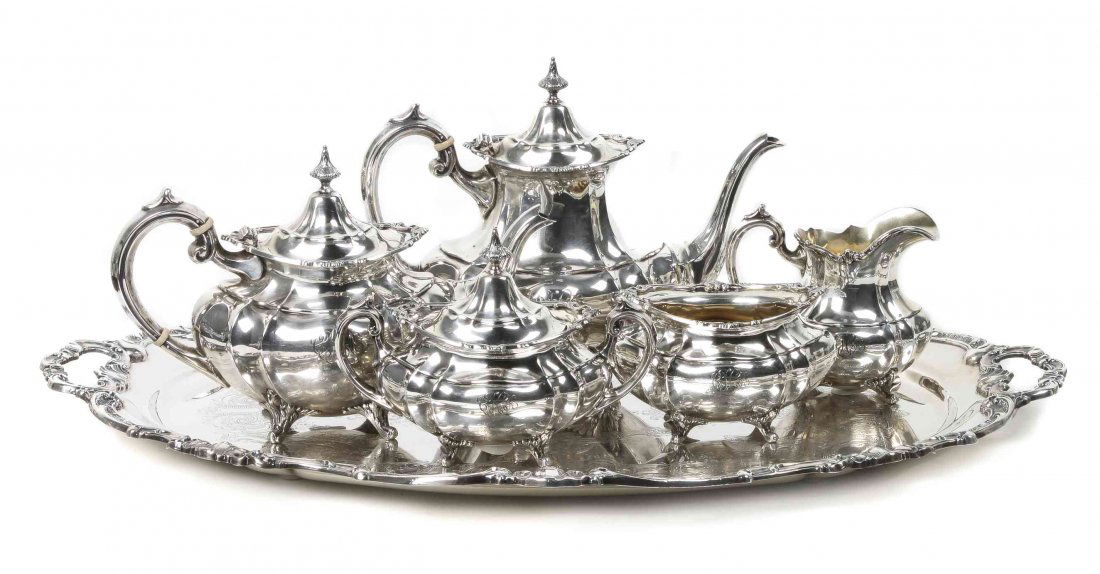 An American Silver Tea and Coffee Service, Length of: An American Silver Tea and Coffee Service, REED & BARTON, TAUNTON, MA., in the Hampton Court pattern, comprising a coffee pot, a tea pot, a covered sugar bowl, waste bowl and creamer; together with a