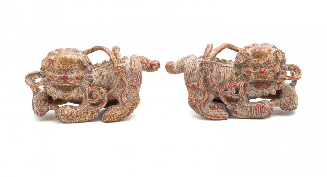A Pair of Decorative Chinese Carved Wood Foo Dogs,: A Pair of Decorative Chinese Carved Wood Foo Dogs, with rubbed gilt finish. Height 4 inches.