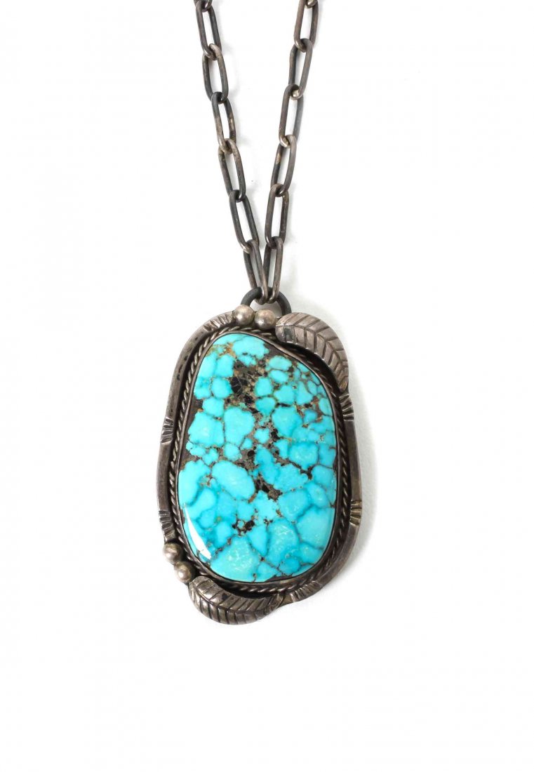 A Southwestern Pendant, Length of chain 23 inches,: A Southwestern Pendant, on a handmade chain, the pendant having a large spider web stone. Length of chain 23 inches, pendant 2 1/4 x 1 1/2 inches.