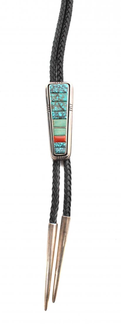 A Navajo Silver and Coral Bolo Tie, Leroy Begay, Height: A Navajo Silver and Coral Bolo Tie, Leroy Begay, having oblong shadow box setting with stacked turquoise and coral stones in a frame, signed "L Begay." Height 3 x width 1 inches. Property from the Col