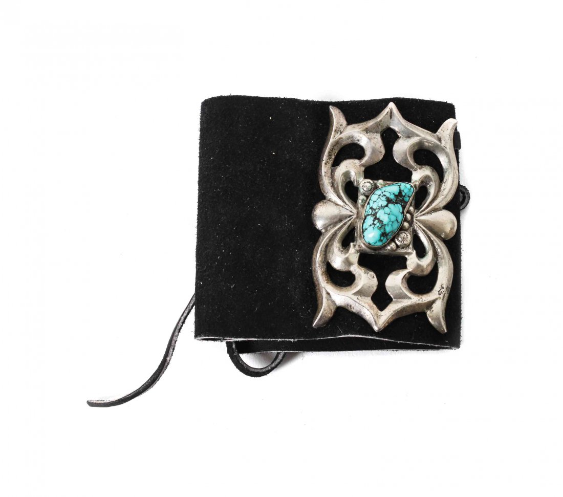 A Navajo Sand-Cast Ketoh, Height 3 3/4 x width 2 1/2: A Navajo Sand-Cast Ketoh, having central turquoise nugget on new leather mount. Height 3 3/4 x width 2 1/2 inches. Property sold to benefit The Humphrey Memorial Park and Museum Collection Conservatio