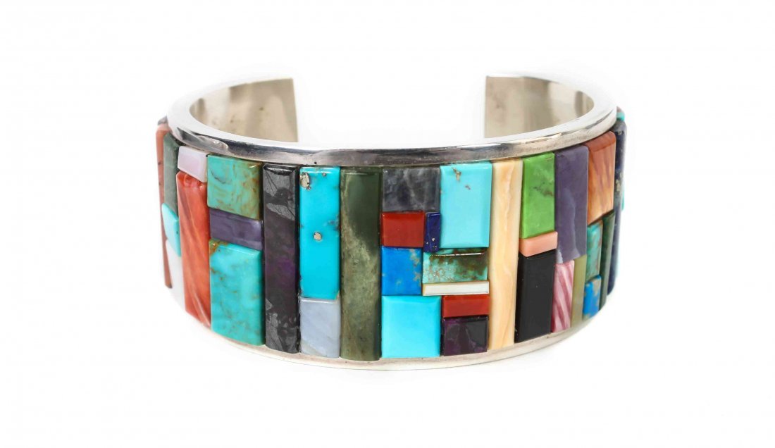 A Navajo Sterling Silver Bracelet, Ted Draper, Jr.,: A Navajo Sterling Silver Bracelet, Ted Draper, Jr., having multi-stone geometric inlay of blue and green turquoise, sugilite, coral ironwood, gaspeite, variscite, spiny oyster, lapis and mother of pea