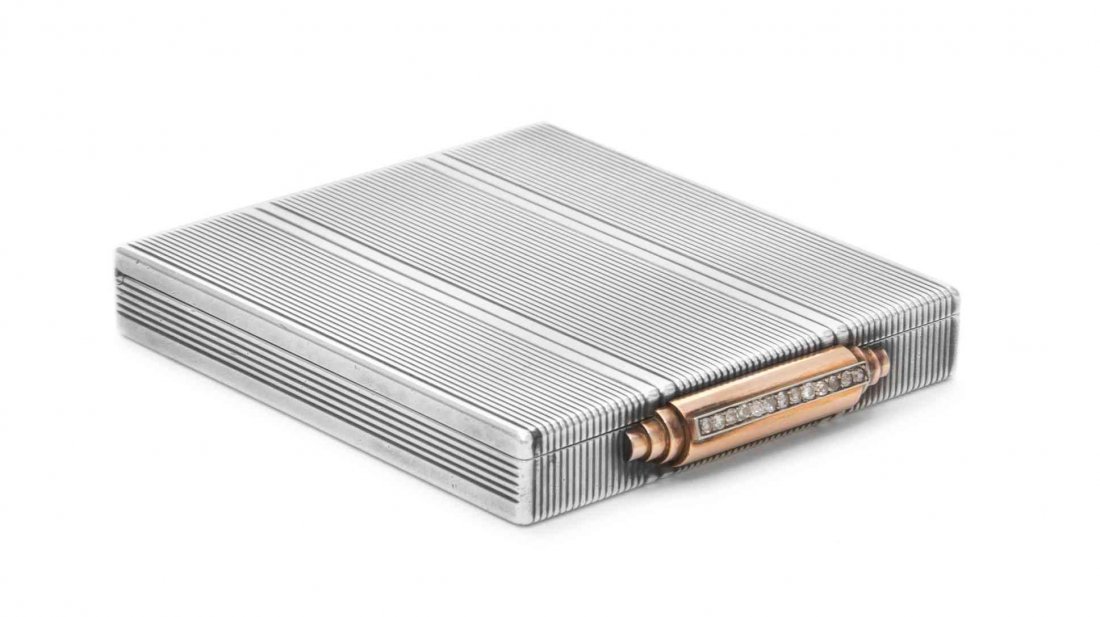A French Gold and Diamond-Mounted Silver Compact,: A French Gold and Diamond-Mounted Silver Compact Boucheron, Paris, Circa 1930 rectangular, decorated overall with incised bands and with stepped gold thumbpiece mounted set with thirteen diamonds, the