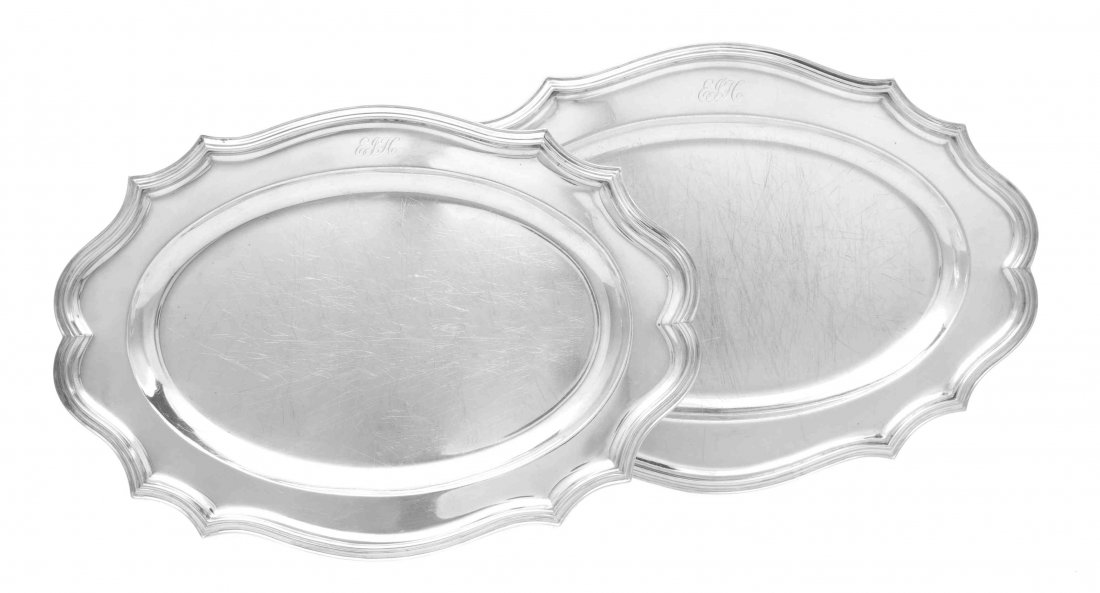 Two Similar English Silver Meat Platters, Thomas: Two Similar English Silver Meat Platters Thomas Bradbury & Sons, London, 1931/ Peter Guille Ltd., London, 1939 both shaped oval with applied reeded rims, the borders engraved with script monograms EJH