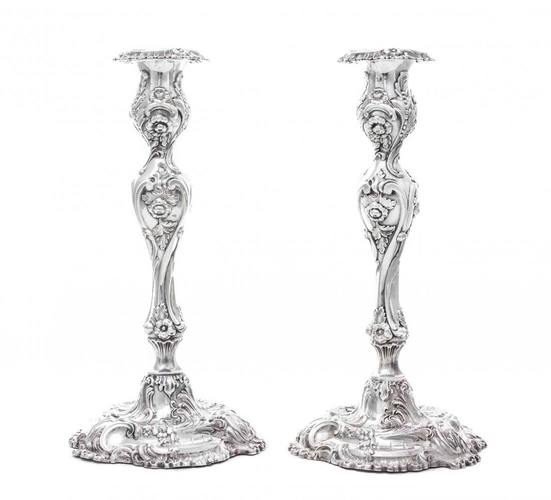 A Pair of Victorian Silver Candlesticks, Henry: A Pair of Victorian Silver Candlesticks Henry Wilkinson & Co., Sheffield, 1855 on shaped circular bases with baluster stems, chased overall with sprays of flowers, rocaille and scrolls, conforming det