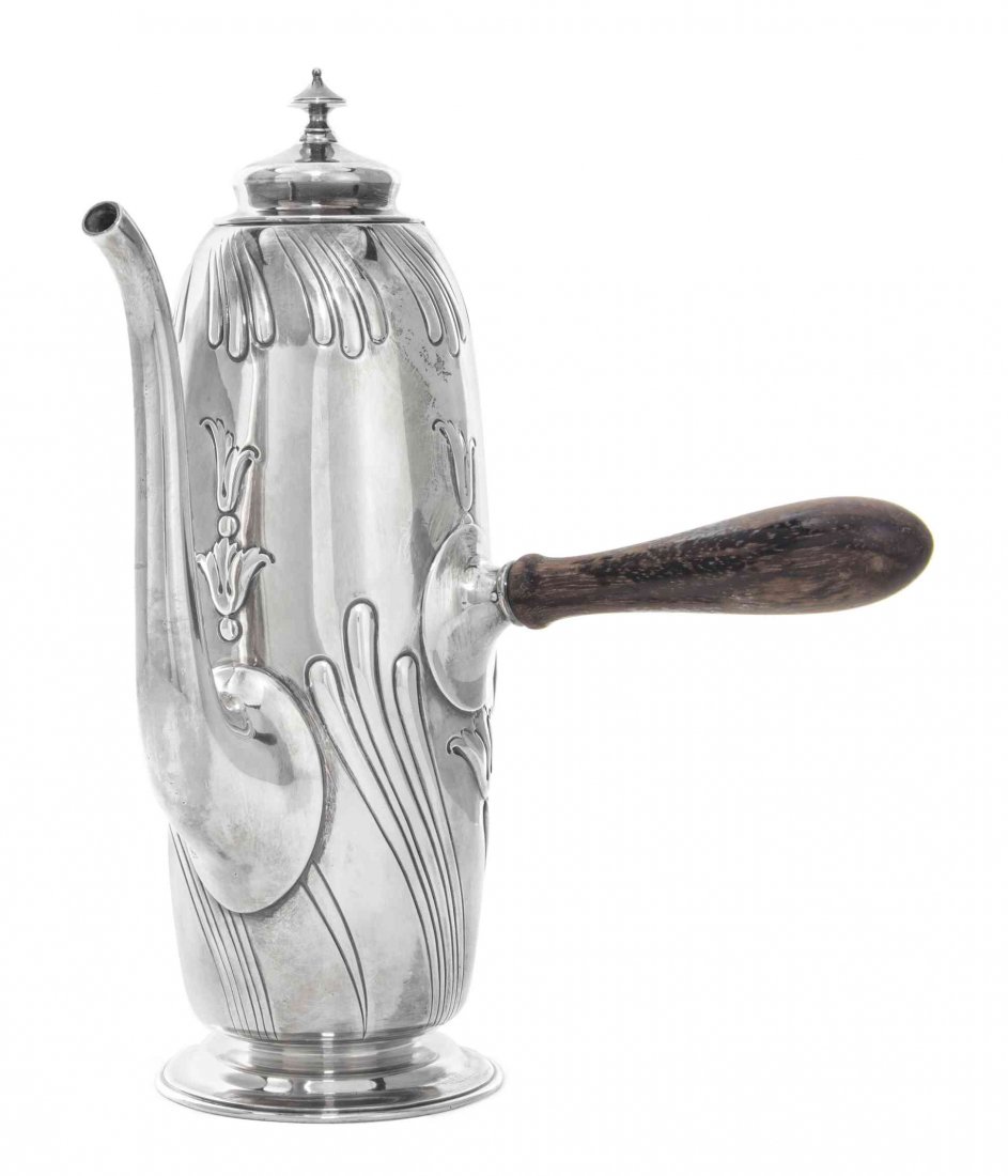 An American Silver Coffee Pot, Dominick & Haff, New: An American Silver Coffee Pot Dominick & Haff, New York, NY, 1892 of ovoid form, chased with sweeping lobes and bellflower pendants, the ebonized wood handle at right angle to curved spout marked on u