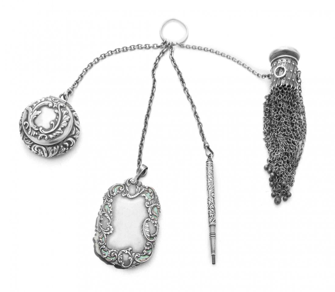 An American Silver Chatelaine, Maker's Mark a Lyre,: An American Silver Chatelaine Maker's Mark a Lyre, Early 20th Century comprising a mesh bag, compact, writing tablet, and pencil holder, all on chains linked to suspension loop, cap of bag engraved wi