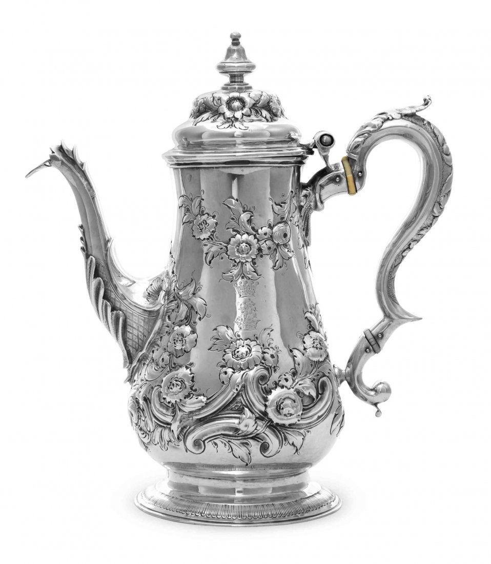A George III Silver Coffee Pot, John King, London,: A George III Silver Coffee Pot John King, London, 1776 of pear form, later chased with scrolls, flowers and floral swags, engraved on both sides with crest under an earl's coronet, the spout decorated