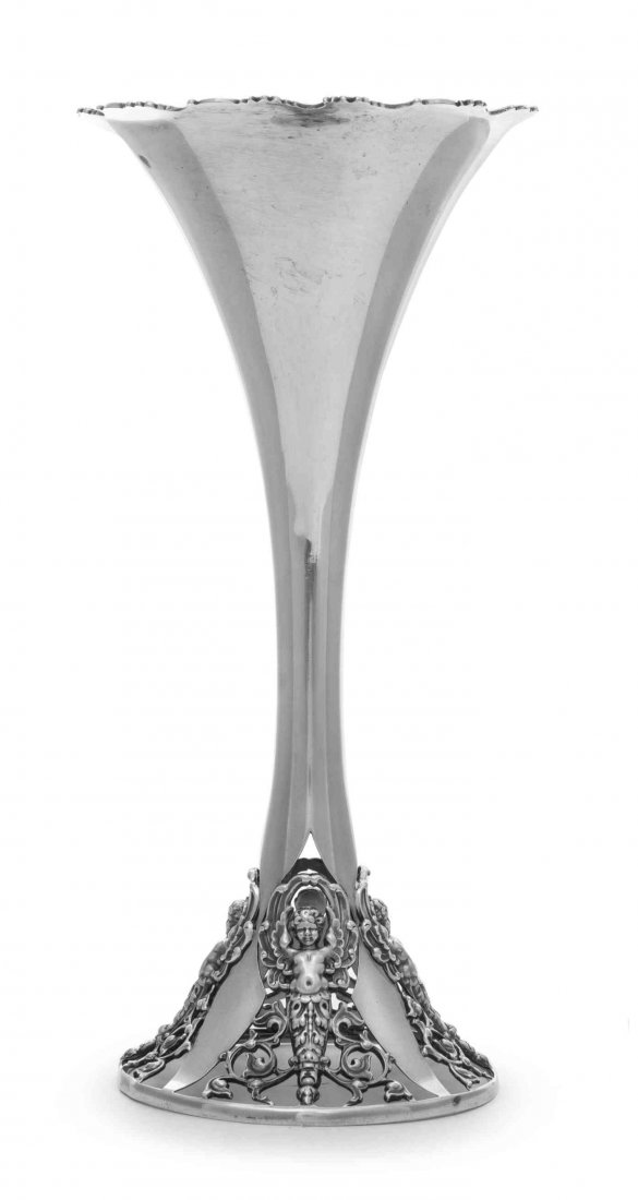 An American Silver Vase, George W. Shiebler & Co., New: An American Silver Vase George W. Shiebler & Co., New York, NY, Circa 1900 of trumpet form with flower and scroll rim, the base pierced and cast with winged caryatids spaced by scrolling foliage and v