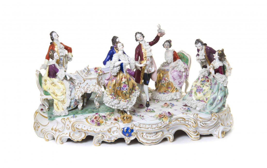 A Continental Porcelain Figural Group, Width 29 inches.: A Continental Porcelain Figural Group, depicting four couples in 18th century attire, two couples seated, one dancing, and one playing the piano. Width 29 inches. Condition: Overall good stable condit