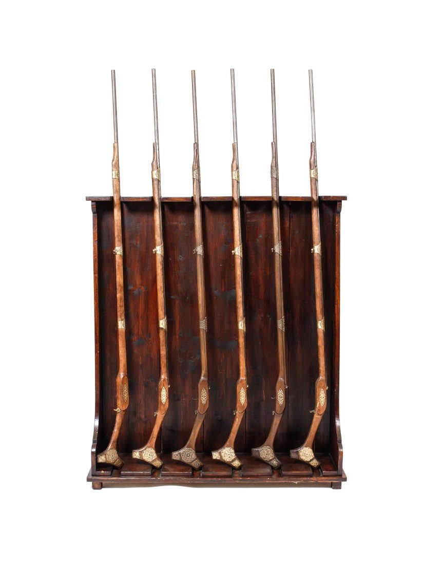 An English Style Mahogany Gun Rack, Height 57 x width: An English Style Mahogany Gun Rack, with six decorative rifles. Height 57 x width 51 x depth 11 3/4 inches; overall height with rifles 83 inches.