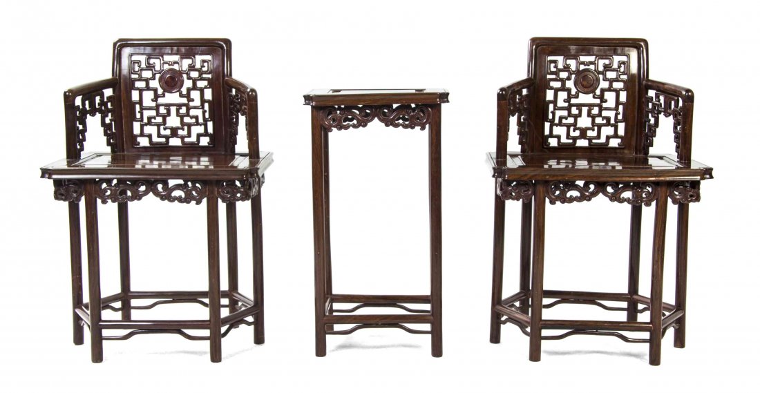 A Chinese Carved Hardwood Parlour Suite, Height 30 3/4: A Chinese Carved Hardwood Parlour Suite, comprising a pair of armchairs and a tea table, the chairs having squared and pierced geometrically carved backs raised on hexagonal bases, each having pierce