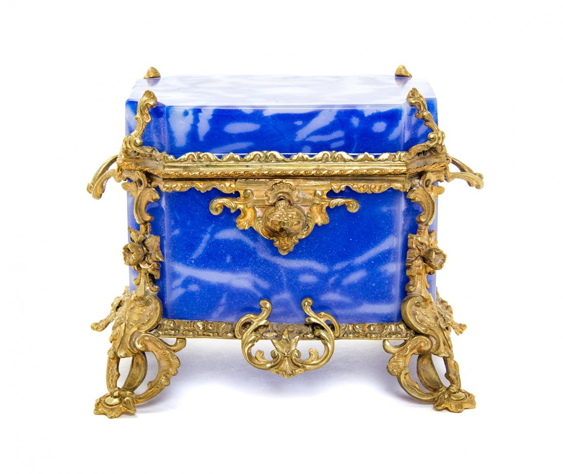 A Neoclassical Style Gilt Metal Mounted Glass Table: A Neoclassical Style Gilt Metal Mounted Glass Table Casket, rectangular, with foliate forms throughout. Width 7 inches.