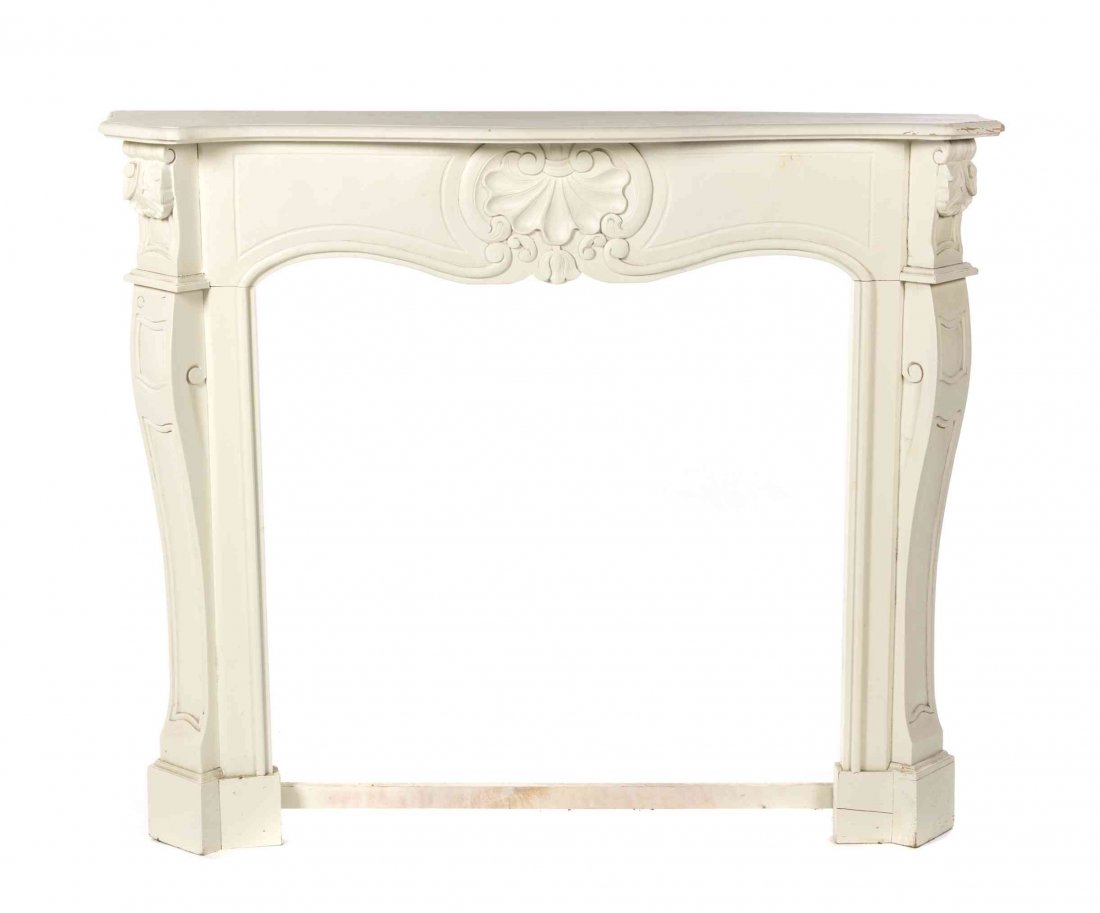 A Painted Pine Mantel, Height 45 3/4 x width 53 x depth: A Painted Pine Mantel, having a serpentine top over a shell carved frieze. Height 45 3/4 x width 53 x depth 9 inches.