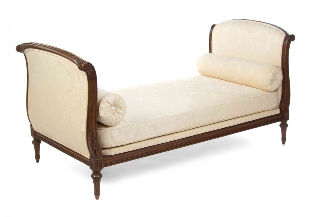 A Louis XV Style Walnut Daybed, Width 82 inches.: A Louis XV Style Walnut Daybed, having upholstered arms and a cushion seat with a ribbon, foliate and rosette carved frame. Width 82 inches.