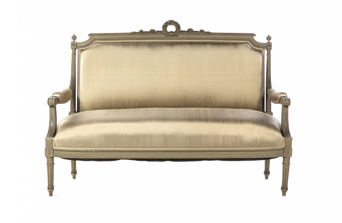 A Louis XVI Style Painted and Parcel Gilt Canape, Width: A Louis XVI Style Painted and Parcel Gilt Canape, having a ribbon tied wreath crest over an upholstered back, arms, and seat, raised on square fluted tapering legs. Width 56 1/2 inches.