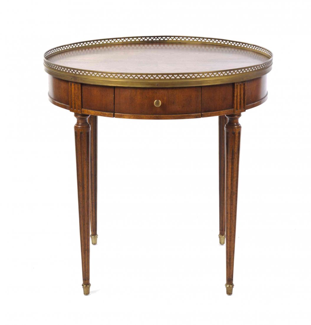 A Louis XVI Style Mahogany Bouillotte Table, Height 25: A Louis XVI Style Mahogany Bouillotte Table, having a circular galleried top over the plain frieze set with a single drawer, raised on fluted tapering legs. Height 25 3/4 x diameter 26 inches.