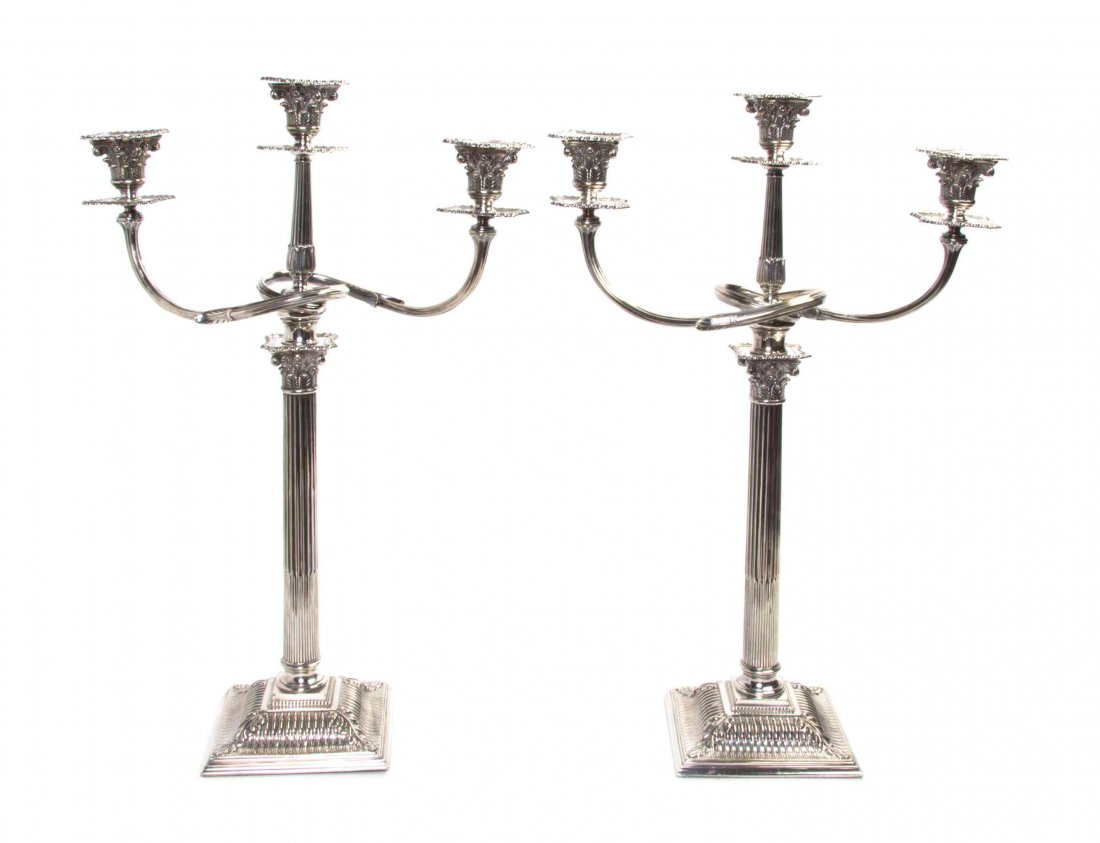 A Pair of English Silver-Plate Three-Light Candelabra,: A Pair of English Silver-Plate Three-Light Candelabra, each with a reeded tapering standard issuing the scrolling candle arms. Height 29 1/2 inches.