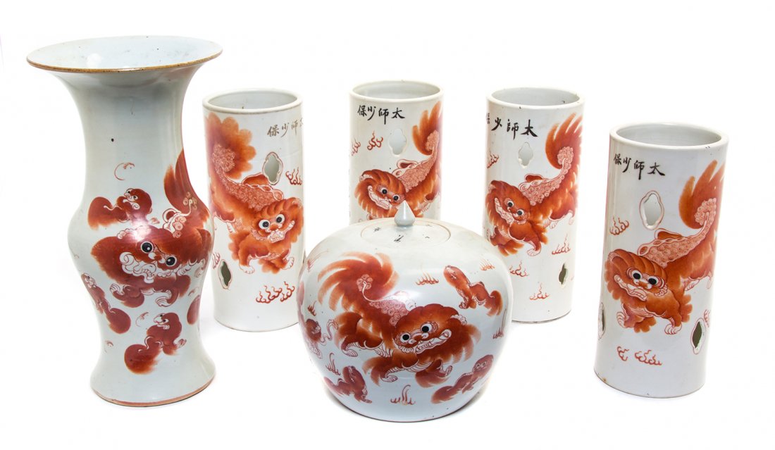 A Chinese Porcelain Garniture, Height of tallest 14: A Chinese Porcelain Garniture, comprising four hat stands, a ginger jar and a baluster form vase, each having iron red Buddhistic lion decoration. Height of tallest 14 inches.