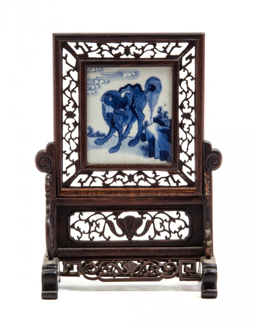 A Chinese Blue and White Porcelain Plaque, Height: A Chinese Blue and White Porcelain Plaque, of rectangular form decorated with a qilin and set in a reticulated wood frame as a table screen. Height overall 9 1/2 inches.