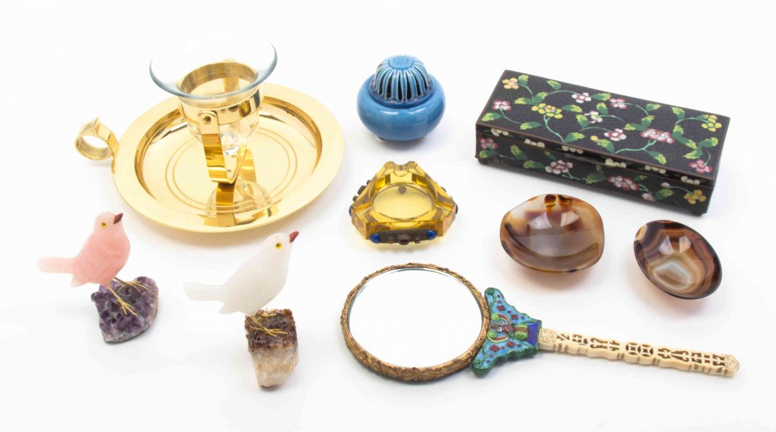 A Group of Decorative and Vanity Objects, Length of: A Group of Decorative and Vanity Objects, comprising a polychrome box, a polychrome hand mirror with an ivorine handle, two agate dishes, an amber ashtray, a bronze and glass hurricane, a blue incense