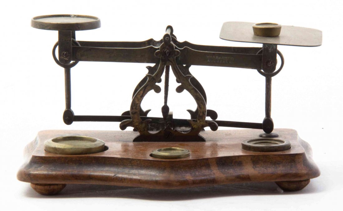 A Brass and Walnut Postage Scale, Width 8 1/4 inches.: A Brass and Walnut Postage Scale, of typical form, with weights. Width 8 1/4 inches. Property from the Abbie R. Lukens Trust, Burr Ridge, Illinois