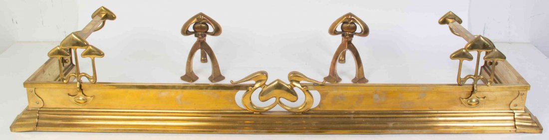 An Art Nouveau Brass Fireplace Set, Length of fender 52: An Art Nouveau Brass Fireplace Set, comprising a fire fender and a pair of andirons. Length of fender 52 1/2 inches. Property from the Estate of Alice Lynne McKee, London, England and Lake Forest, Ill