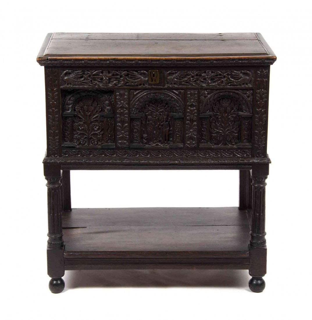 A Renaissance Style Carved Case On Stand, Height 34 7/8: A Renaissance Style Carved Case On Stand, having a rectangular hinged top over the conforming case with carved front and side panels, raised on turned legs joined by a medial shelf. Height 34 7/8 x wi