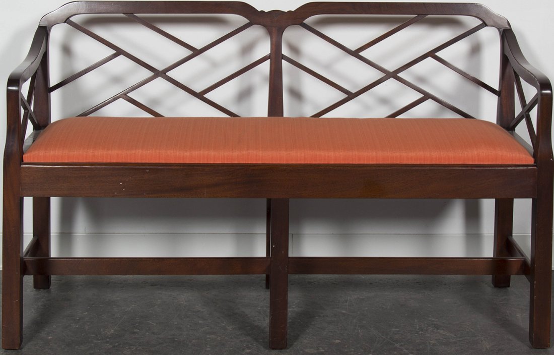 A Chippendale Style Mahogany Window Seat, Width 49 1/2: A Chippendale Style Mahogany Window Seat, having a lattice work back and arms over the upholstered seat. Width 49 1/2 inches.