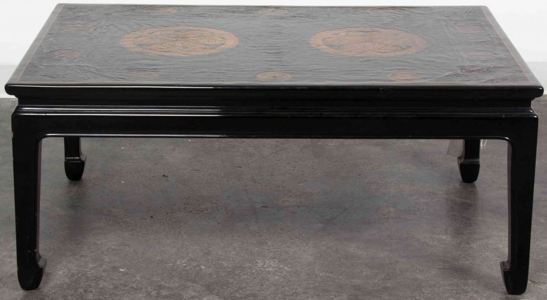 A Japanese Black Lacquer Low Table, Height 17 x width: A Japanese Black Lacquer Low Table, having gilt painted Tokugawa mons to the top, raised on four elephant feet. Height 17 x width 39 7/8 x depth 26 3/4 inches. Property from a Midwest Corporate Collec