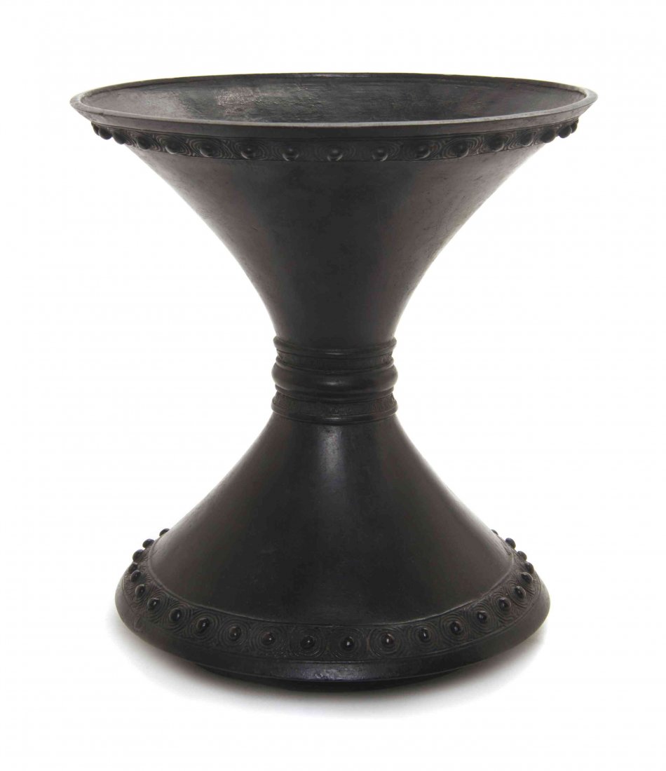 A Japanese Bronze Vessel, Height 9 1/2 inches.: A Japanese Bronze Vessel, of conical form raised above horizontal ribs, with raised bosses and on a flared base. Height 9 1/2 inches.