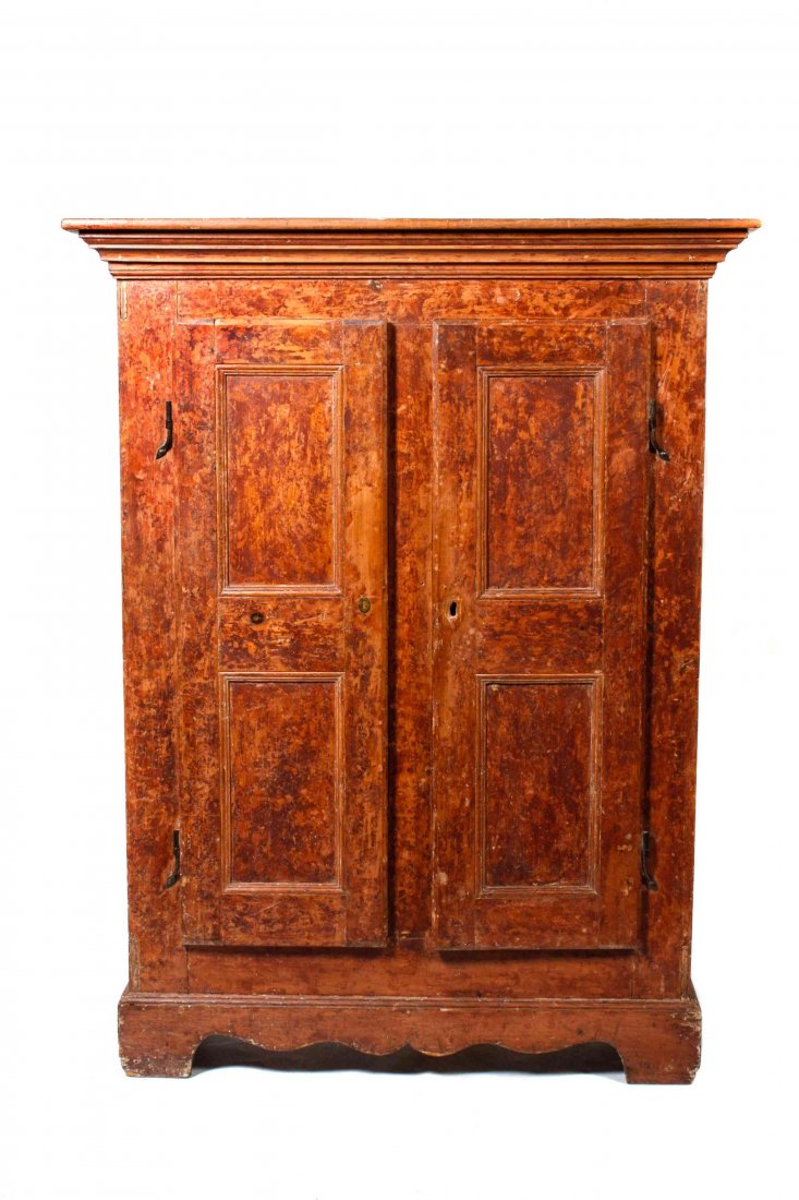A Pennsylvania Dutch Painted Cupboard, Height 70 x: A Pennsylvania Dutch Painted Cupboard, 18TH CENTURY, having a molded cornice above two doors, raised on bracket feet. Height 70 x width 54 x depth 16 1/2 inches. Property from the Estate of Judith Wri