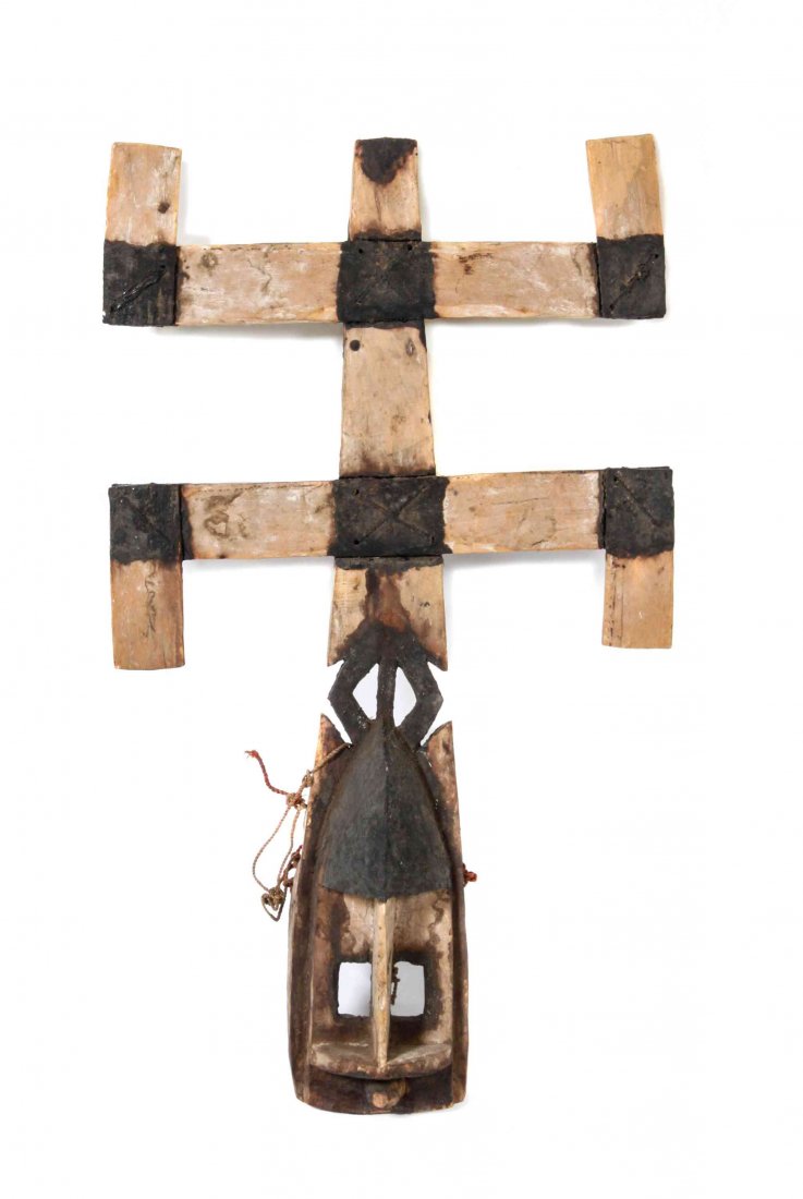 An African Carved Kanaga Mask, Height 37 x width 21: An African Carved Kanaga Mask, from the Dogon tribe, having a stylized geometric face with deep set rectangular eyes, surmounted by a typical double cross. Height 37 x width 21 inches. Property from t