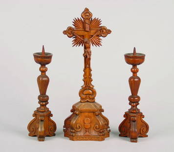 A German Wood Carved Crucifix,: 19th century, together with candle holders; three pieces total.Height of tallest 20 inches.