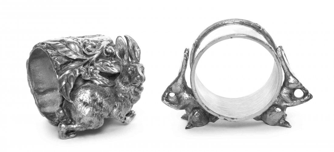 Two American Silver-Plate Figural Napkin Rings with: Two American Silver-Plate Figural Napkin Rings with Rabbits Late 19th Century the first with ring with bound reeded borders supported on the backs of two rabbits, apparently unmarked, the second with 