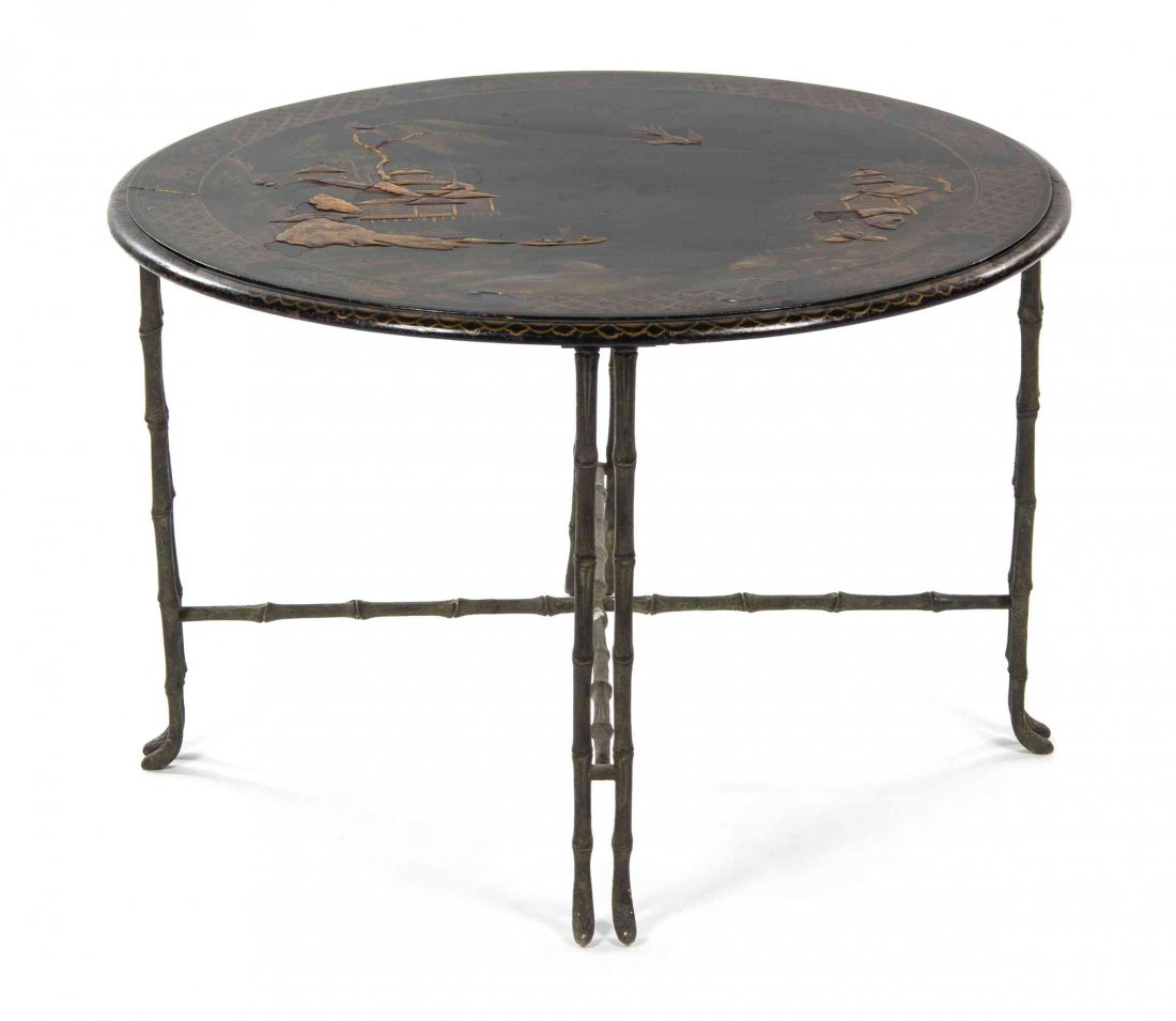A Chinese Export Black and Gilt Lacquered Table Height: A Chinese Export Black and Gilt Lacquered Table having a circular top worked to show an architectural landscape, raised on simulated bamboo supports joined by an X-form stretcher. Height 21 1/2 x diam