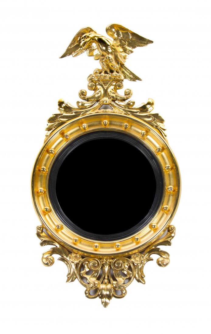 An American Federal Style Giltwood Bullseye Mirror 20TH: An American Federal Style Giltwood Bullseye Mirror 20TH CENTURY WITH EARLIER ELEMENTS having an eagle crest above the convex plate within an ebonized border. Height 38 x width 20 inches. Property from