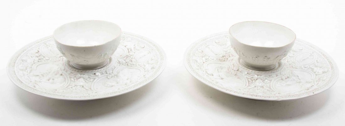 A Pair of German Molded Creamware Bowls and Underplates: A Pair of German Molded Creamware Bowls and Underplates each worked to show classic figures, bearing a blue N and crown mark to the underside. Diameter of platters 16 1/2 inches.