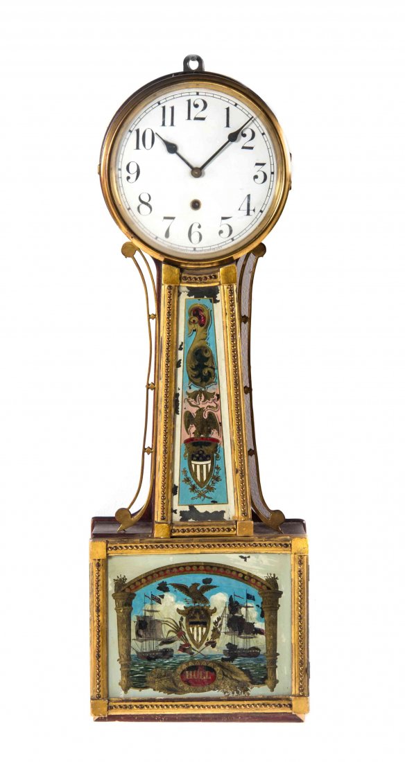 An American Banjo Clock, WATERBURY CLOCK CO., Height 29: An American Banjo Clock WATERBURY CLOCK CO. Willard No. 3, the circular dial having Arabic numerals over the case with an eglomise cover and hinged door depicting a naval scene. Height 29 1/8 inches.