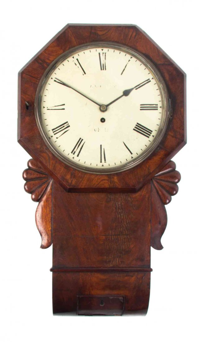 A Regency Mahogany Wall Clock Height 27 inches.: A Regency Mahogany Wall Clock having a circular dial with Roman numerals, set within an octagonal case. Height 27 inches.