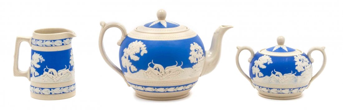 A Copeland Spode Blue and White Jasperware Porcelain: A Copeland Spode Blue and White Jasperware Porcelain Tea Service comprising a teapot, covered sugar and creamer. Height of teapot 6 inches. Property from the Collection of Herb and Roberta Nechin, Chi