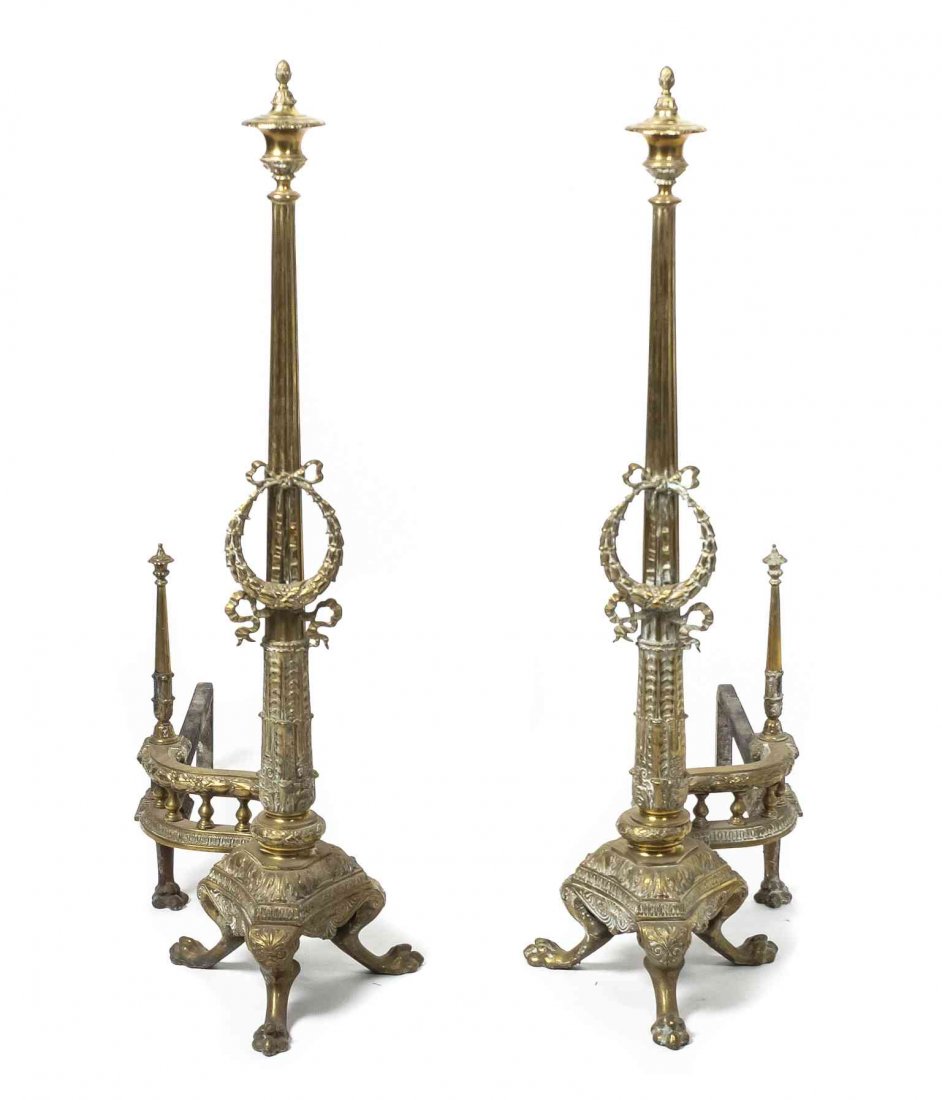 A Monumental Pair of Directoire Style Brass Andirons: A Monumental Pair of Directoire Style Brass Andirons having urn finials atop columns with classically designed capitals, reeded tapering columns mounted with acanthus leaf garland above palmette encir